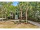 Charming home nestled among lush greenery, framed by palm trees and landscaped yard at 486 Lantana Circle, Georgetown, SC 29440