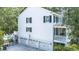 Side angle of a home with a three car garage, open patio, and second story porch at 486 Lantana Circle, Georgetown, SC 29440