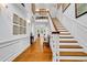 Grand foyer with beautiful hardwood floors, staircase, and elegant decor, creating a warm welcome at 486 Lantana Circle, Georgetown, SC 29440