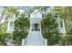 Traditional home featuring a welcoming front porch, grand staircase, and manicured landscaping at 486 Lantana Circle, Georgetown, SC 29440