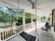 Inviting front porch with comfortable rocking chairs and a hanging swing at 486 Lantana Circle, Georgetown, SC 29440
