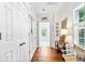 Hallway featuring hardwood floors, white walls and trim, and several storage closets at 486 Lantana Circle, Georgetown, SC 29440