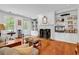 Bright living room featuring a fireplace, built-in bookshelves, and hardwood floors at 486 Lantana Circle, Georgetown, SC 29440