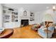 Stylish living room with hardwood floors, built-in bookcases, and a cozy fireplace at 486 Lantana Circle, Georgetown, SC 29440