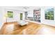 Light-filled living room with hardwood floors, a ceiling fan, and custom bookshelves at 486 Lantana Circle, Georgetown, SC 29440