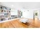 Living room with hardwood floors, a ceiling fan, and custom bookshelves at 486 Lantana Circle, Georgetown, SC 29440