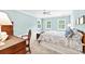 Light-filled main bedroom boasts a ceiling fan, three large windows, and a calming color palette at 486 Lantana Circle, Georgetown, SC 29440