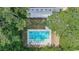 Aerial view of a pool, with surrounding lawn, patio furniture, and mature landscaping at 486 Lantana Circle, Georgetown, SC 29440