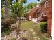Scenic backyard featuring a well-manicured lawn, trees, and stone walkway near a brick house at 618 6Th Ave. N, Surfside Beach, SC 29575