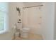 Bright bathroom with a white toilet, tiled floor, and a shower-tub combination at 618 6Th Ave. N, Surfside Beach, SC 29575