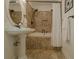 Elegant bathroom with tiled walls, a pedestal sink, and a luxurious bathtub with a shower at 618 6Th Ave. N, Surfside Beach, SC 29575