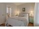 Bedroom with queen-size bed, hardwood floors, ensuite bathroom and neutral decor at 618 6Th Ave. N, Surfside Beach, SC 29575