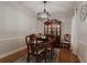 Dining room featuring wood table and hutch with a modern chandelier and hardwood floors at 618 6Th Ave. N, Surfside Beach, SC 29575
