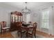 Dining room featuring wood table and hutch with a modern chandelier and hardwood floors at 618 6Th Ave. N, Surfside Beach, SC 29575