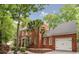 Beautiful brick home with a 2 car garage surrounded by mature trees and landscaping at 618 6Th Ave. N, Surfside Beach, SC 29575