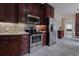 Modern kitchen boasts stainless appliances, stone countertops, and wood cabinets at 618 6Th Ave. N, Surfside Beach, SC 29575