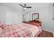 This bedroom features a double door closet, ceiling fan, and a cherry-wood frame bed with matching dresser at 706 Birch Ln., Conway, SC 29526