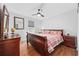 Cozy bedroom featuring a cherry-wood frame bed, matching dresser with mirror, and a ceiling fan at 706 Birch Ln., Conway, SC 29526
