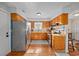 Efficient kitchen featuring stainless steel refrigerator and breakfast bar and wood cabinets at 706 Birch Ln., Conway, SC 29526