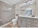 Bathroom featuring a glass enclosed shower with decorative tile, vanity with storage, and neutral wall paint at 800 9Th Ave. S # A-4, North Myrtle Beach, SC 29582
