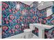 Stylish half-bathroom with vibrant wallpaper, pedestal sink, and contemporary fixtures at 800 9Th Ave. S # A-4, North Myrtle Beach, SC 29582
