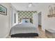 Relaxing bedroom featuring wood-look floors, bright green leaf wallpaper, queen bed, and natural light from the window at 800 9Th Ave. S # A-4, North Myrtle Beach, SC 29582