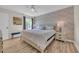 Bright bedroom features wood floors, ceiling fan, accent wall, natural light from window, and stylish furnishings at 800 9Th Ave. S # A-4, North Myrtle Beach, SC 29582