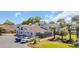 Charming townhome showcasing a modern design, a private fenced patio, and a well-maintained landscape with tropical trees at 800 9Th Ave. S # A-4, North Myrtle Beach, SC 29582