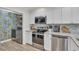 Bright kitchen boasts stainless appliances, white cabinets, granite countertops, and adjacent laundry area at 800 9Th Ave. S # A-4, North Myrtle Beach, SC 29582