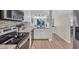Modern kitchen showcases stainless steel appliances, white cabinets, and open floorplan to dining area at 800 9Th Ave. S # A-4, North Myrtle Beach, SC 29582