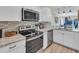 Well-lit kitchen featuring stainless steel appliances, granite countertops, and stylish tile backsplash at 800 9Th Ave. S # A-4, North Myrtle Beach, SC 29582