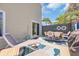 Private patio with lounge chairs, dining set, and decorative outdoor rug, ideal for relaxation at 800 9Th Ave. S # A-4, North Myrtle Beach, SC 29582