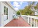 A large back deck has a white railing and blue chairs and tables for outdoor enjoyment at 820 9Th Ave. S, North Myrtle Beach, SC 29582