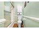A well-lit bathroom features a toilet, and a glass shower with a white shower-head at 820 9Th Ave. S, North Myrtle Beach, SC 29582