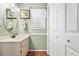 This half-bathroom features a sink, mirror, window, and a two-door linen closet at 820 9Th Ave. S, North Myrtle Beach, SC 29582