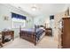 A bedroom features carpet floors and a wooden bed between two side tables and a dark wood dresser at 820 9Th Ave. S, North Myrtle Beach, SC 29582