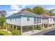 Coastal home featuring a stilt foundation, screened porch, and manicured landscaping at 820 9Th Ave. S, North Myrtle Beach, SC 29582