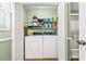 A laundry room is home to a dryer and washing machine on a wood floor with wire shelving at 820 9Th Ave. S, North Myrtle Beach, SC 29582