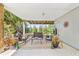 Relaxing covered patio featuring stylish outdoor furniture and view of the landscaped backyard at 820 9Th Ave. S, North Myrtle Beach, SC 29582
