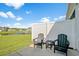Relaxing back patio featuring comfortable Adirondack chairs with a tranquil water view at 830 San Marco Ct. # 2603-B, Myrtle Beach, SC 29579