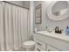 Bright bathroom featuring a vanity with modern fixtures, a round mirror, and neutral shower curtain at 830 San Marco Ct. # 2603-B, Myrtle Beach, SC 29579