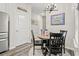 Charming dining area featuring a round wood table, decorative chandelier, and wood-look flooring at 830 San Marco Ct. # 2603-B, Myrtle Beach, SC 29579