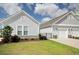 Single-story home featuring stone accents, manicured lawn, and a two-car garage at 830 San Marco Ct. # 2603-B, Myrtle Beach, SC 29579