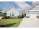 Charming single-story home featuring stone accents, manicured lawn, and a two-car garage at 830 San Marco Ct. # 2603-B, Myrtle Beach, SC 29579
