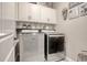 Functional laundry room with modern appliances, overhead cabinets, and stylish decor at 830 San Marco Ct. # 2603-B, Myrtle Beach, SC 29579