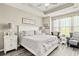 Spacious main bedroom with wood floors, tray ceilings, and a large window for natural light at 830 San Marco Ct. # 2603-B, Myrtle Beach, SC 29579
