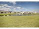 Scenic view of a pond with a fountain, surrounded by well-maintained lawns and neighborhood homes at 830 San Marco Ct. # 2603-B, Myrtle Beach, SC 29579