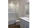 Bright bathroom featuring white subway tile, matching cabinets, and a modern sink at 958 Oak Hollow St., Longs, SC 29568