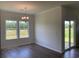 Bright dining room featuring windows to the back yard, a chandelier, and sliding glass door to patio at 958 Oak Hollow St., Longs, SC 29568