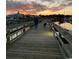A calm view of a Personal walking a dog on the marina boardwalk during sunrise at 958 Oak Hollow St., Longs, SC 29568